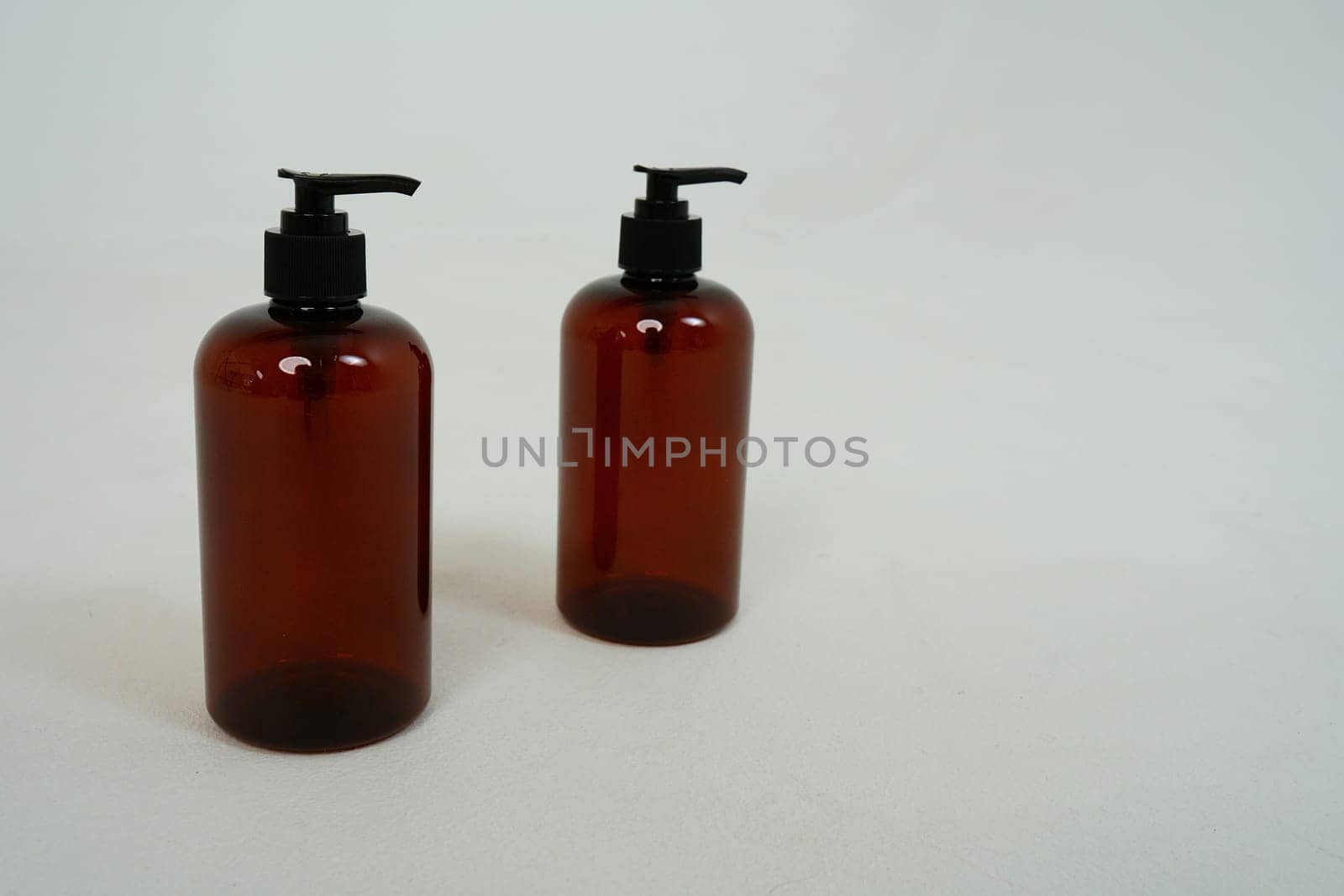 Two dark bottles with soap dispensers on a white background. isolated on white background. High quality photo