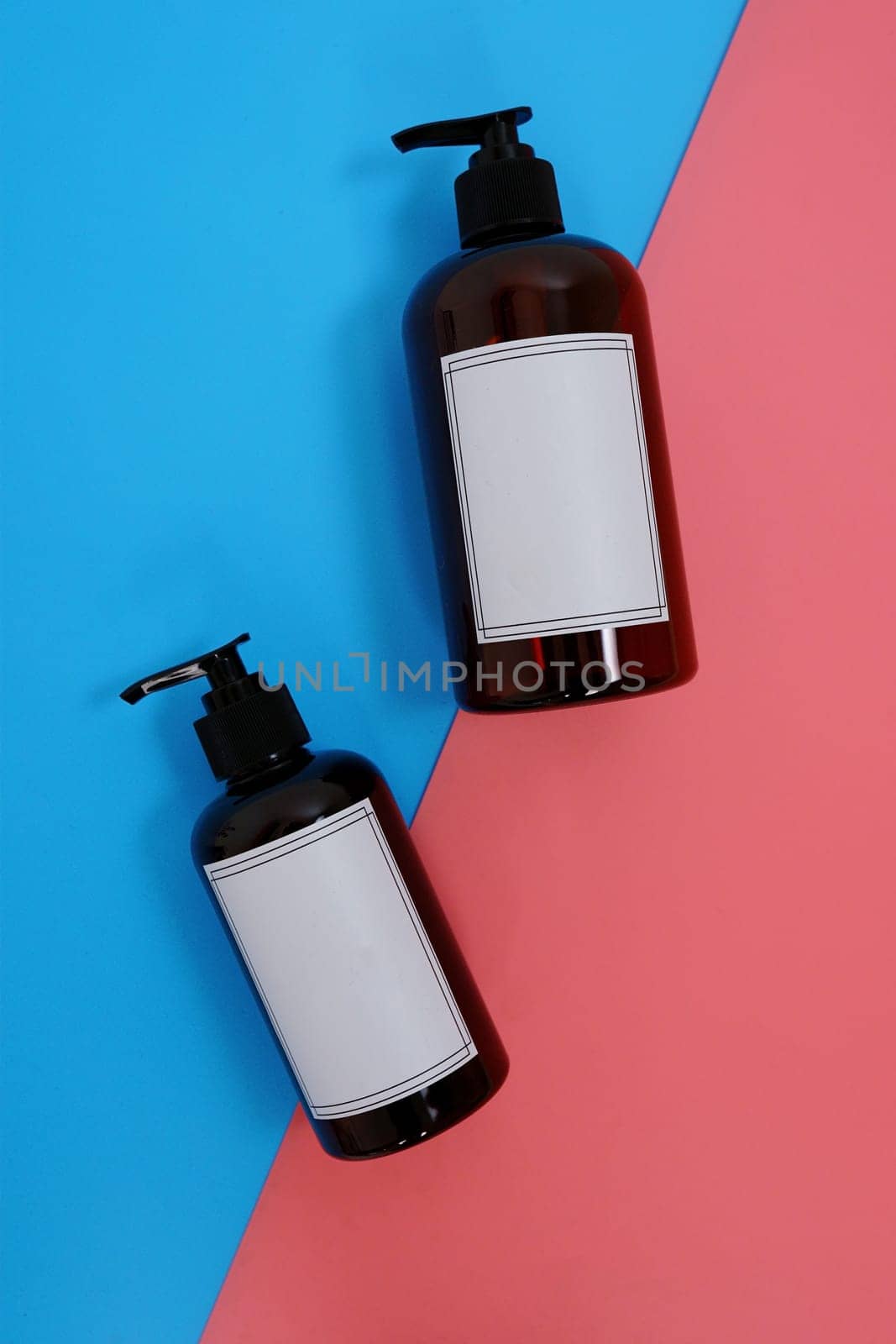 Body care. set of bottles with dispensers on a blue and pink background. Advertising concept. High quality photo