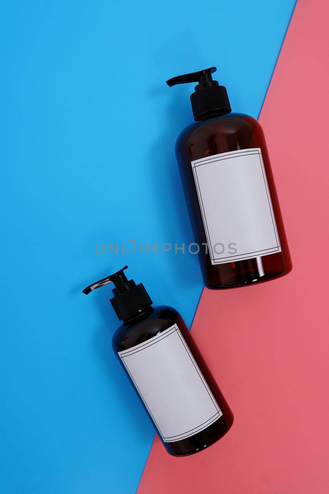 Body care. set of bottles with dispensers on a blue and pink background. Advertising concept by tewolf