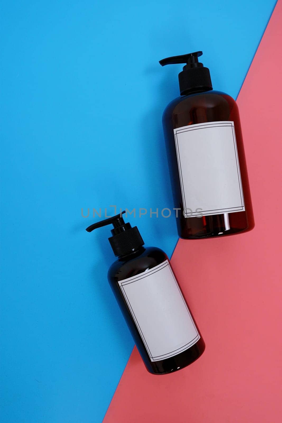 Body care. set of bottles with dispensers on a blue and pink background. Advertising concept. High quality photo