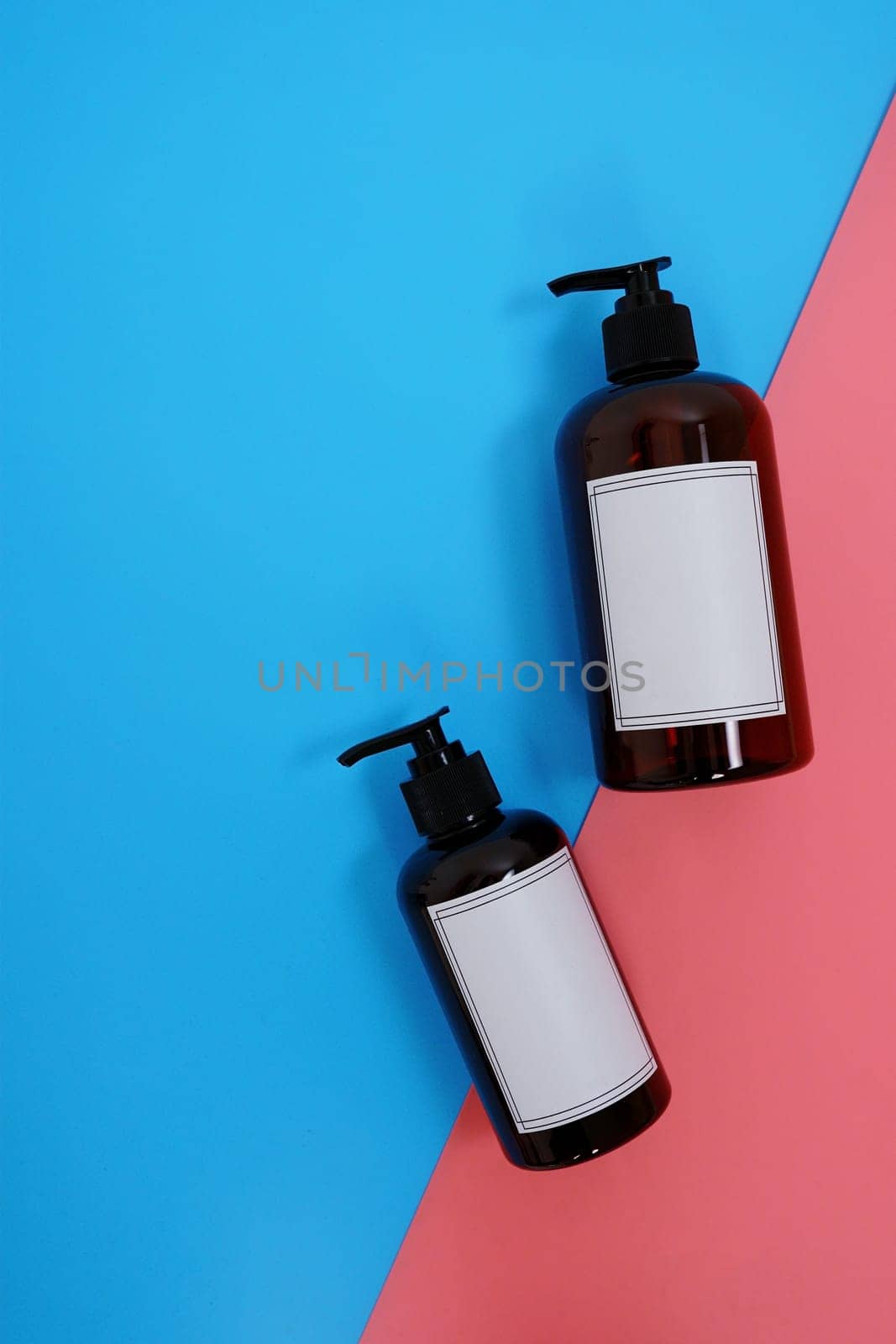 Body care. set of bottles with dispensers on a blue and pink background. Advertising concept. High quality photo