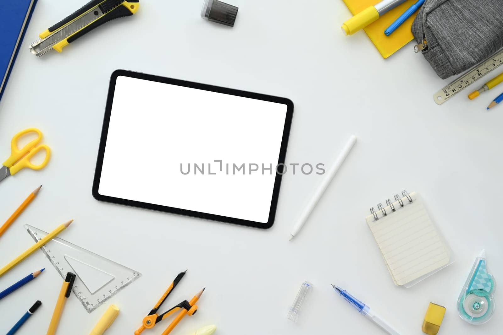 Digital tablet with blank screen and school supplies on white background. Back to school concept.