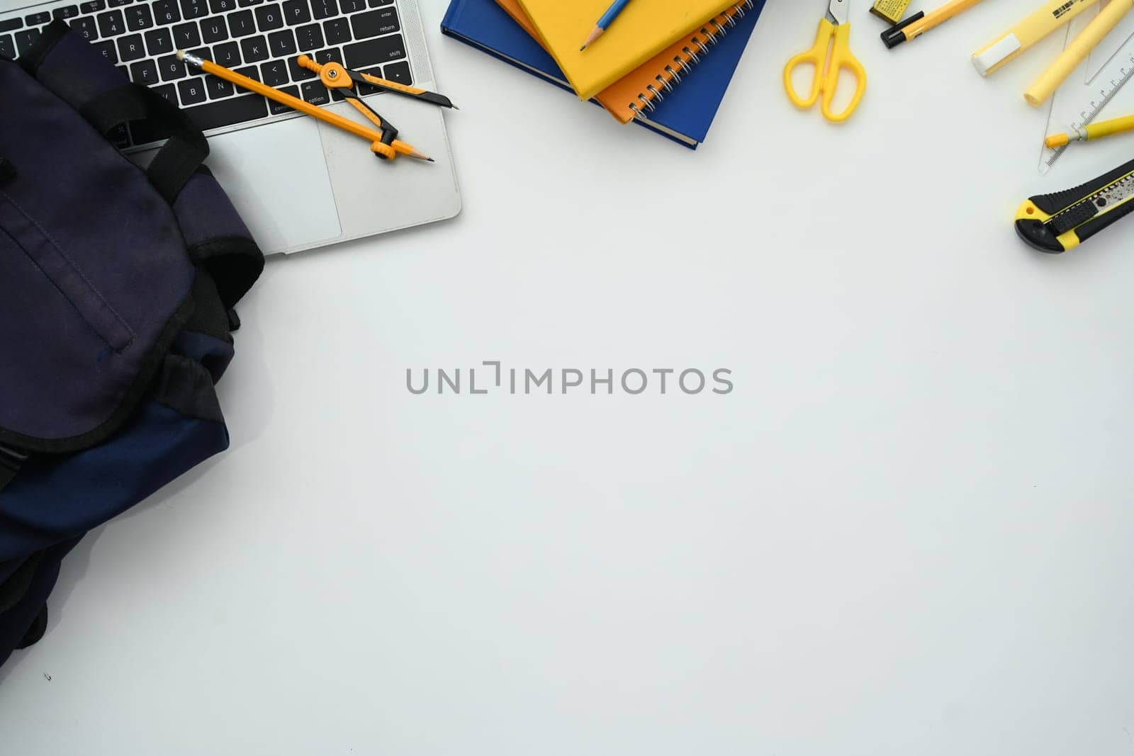 Laptop, backpack and school stationery on white background. International day of education concept.