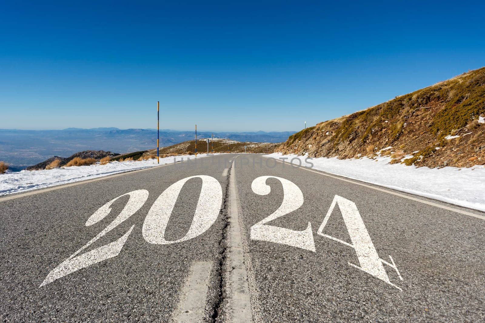 2024 New Year road trip travel and future vision concept . Nature landscape with highway road leading forward to happy new year celebration in the beginning of 2024 for fresh and successful start
