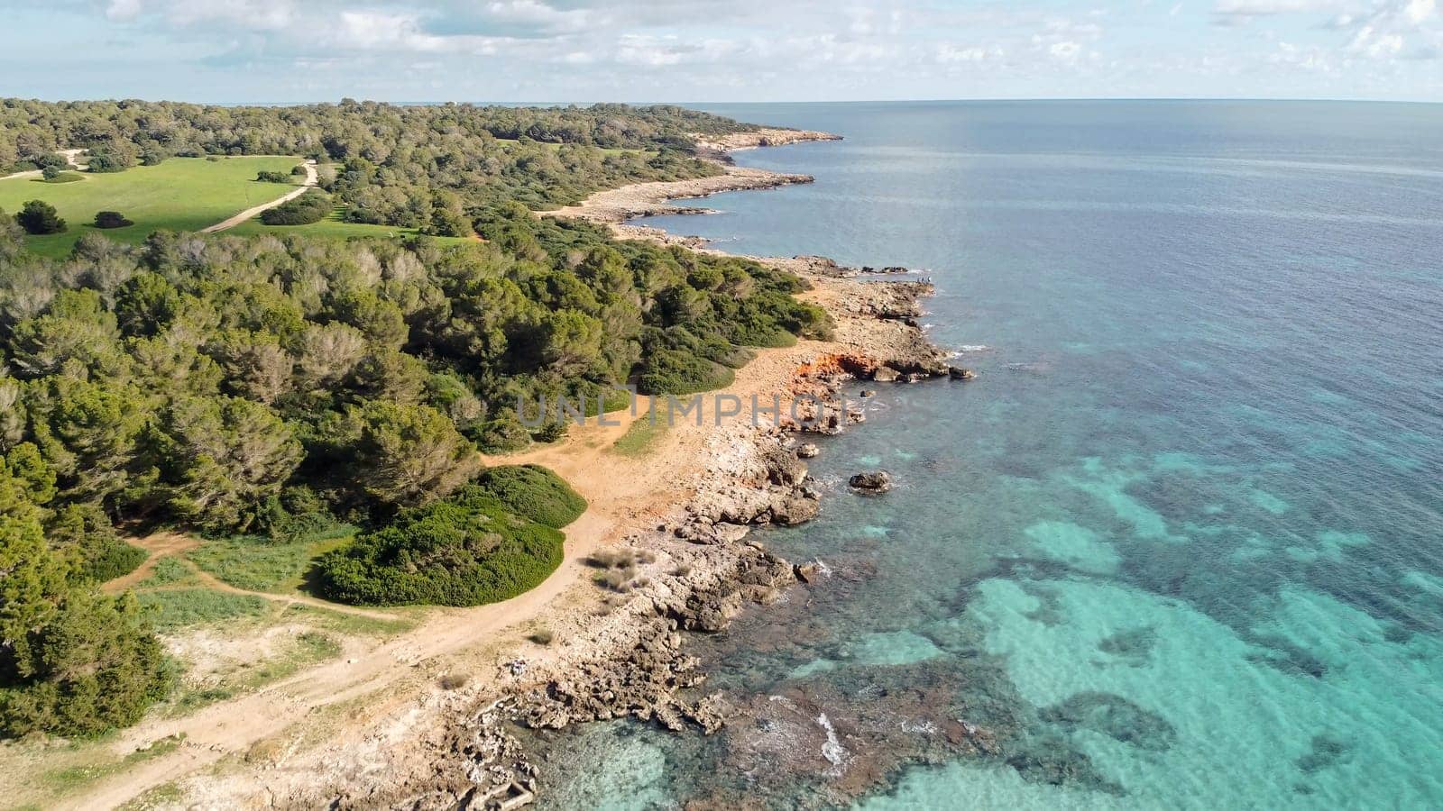aerial view from drone of a natural paradise beach in the mediterranean, with crystal clear water and white sand. sa Coma Mallorca, Balearic Islands