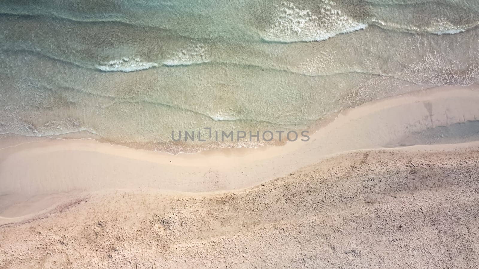 aerial view from drone of a natural paradise beach in the mediterranean, with crystal clear water and white sand. sa Coma Mallorca, Balearic Islands