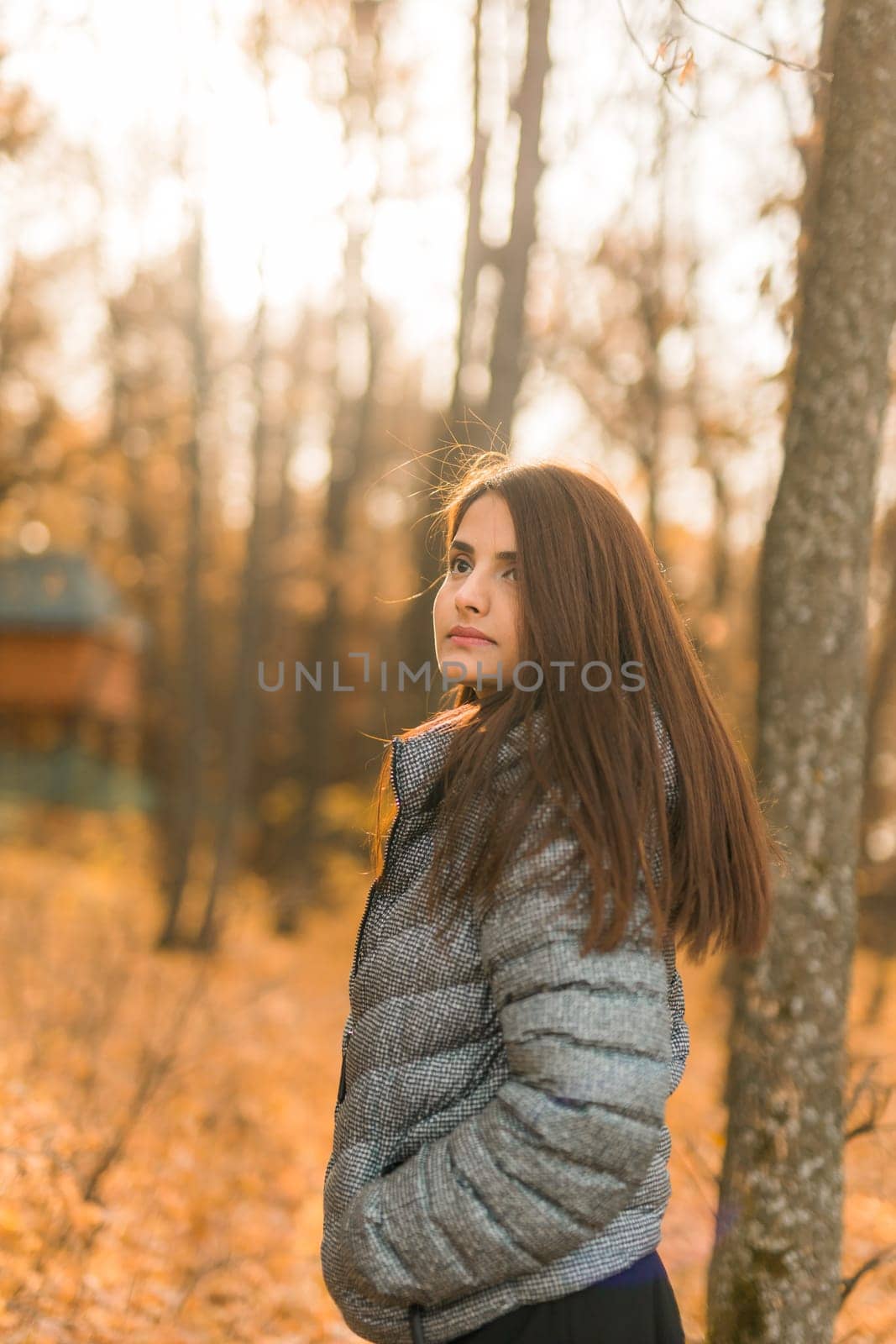 Close up portrait of pretty indian young woman enjoying warm autumn sunny day vacation outdoors. Generation z and gen z concept. Fall Season.