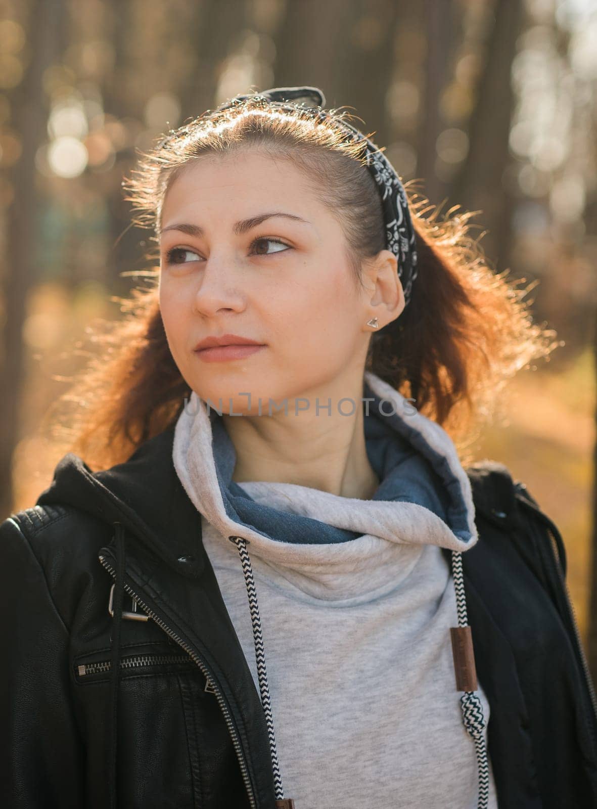 Outdoor atmospheric lifestyle portrait of young beautiful young woman. Warm autumn fall season copy space