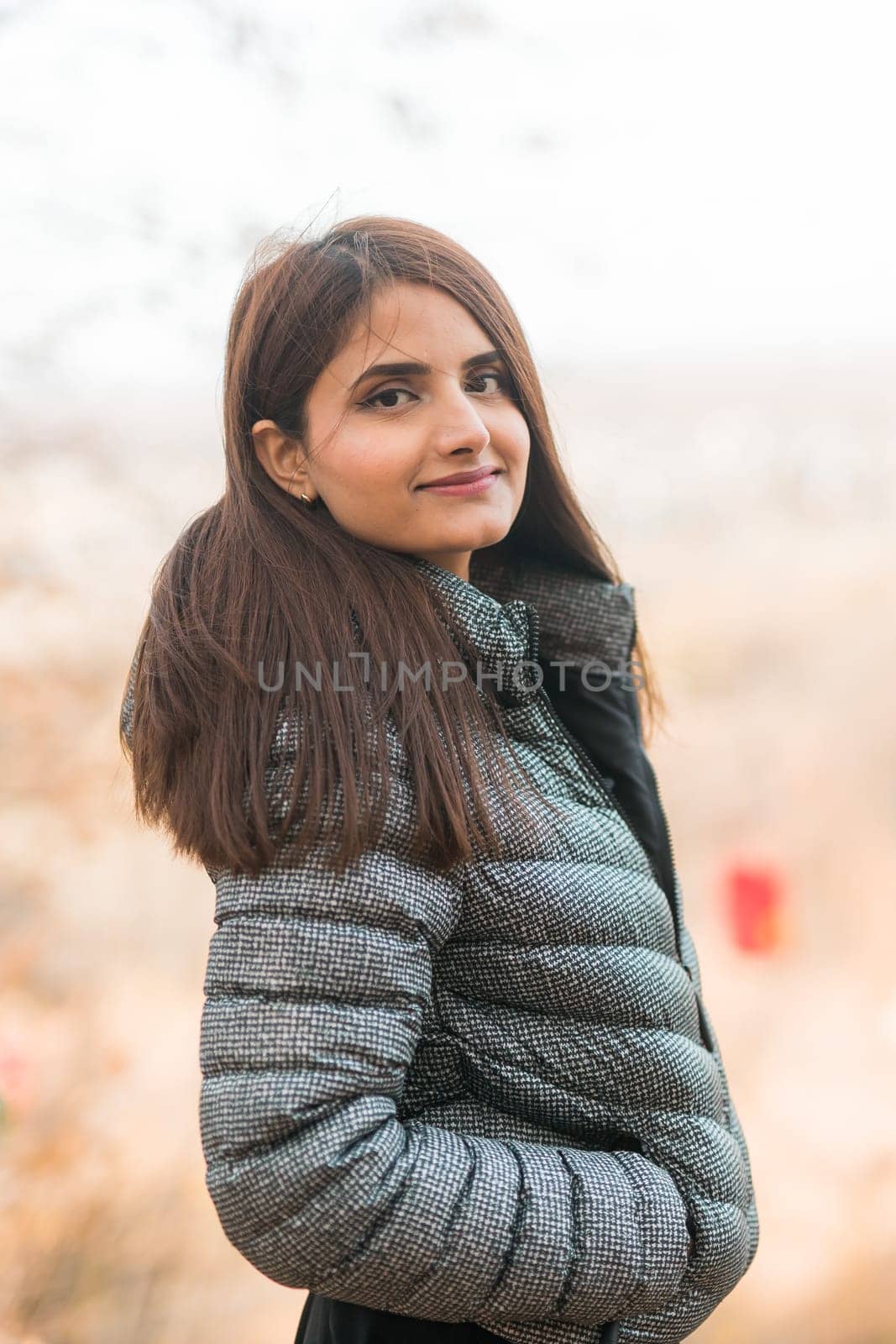 Close up portrait of pretty indian young woman enjoying warm autumn sunny day vacation outdoors against background of cable car. copy space mockup. Generation z and gen z concept. Fall Season by Satura86