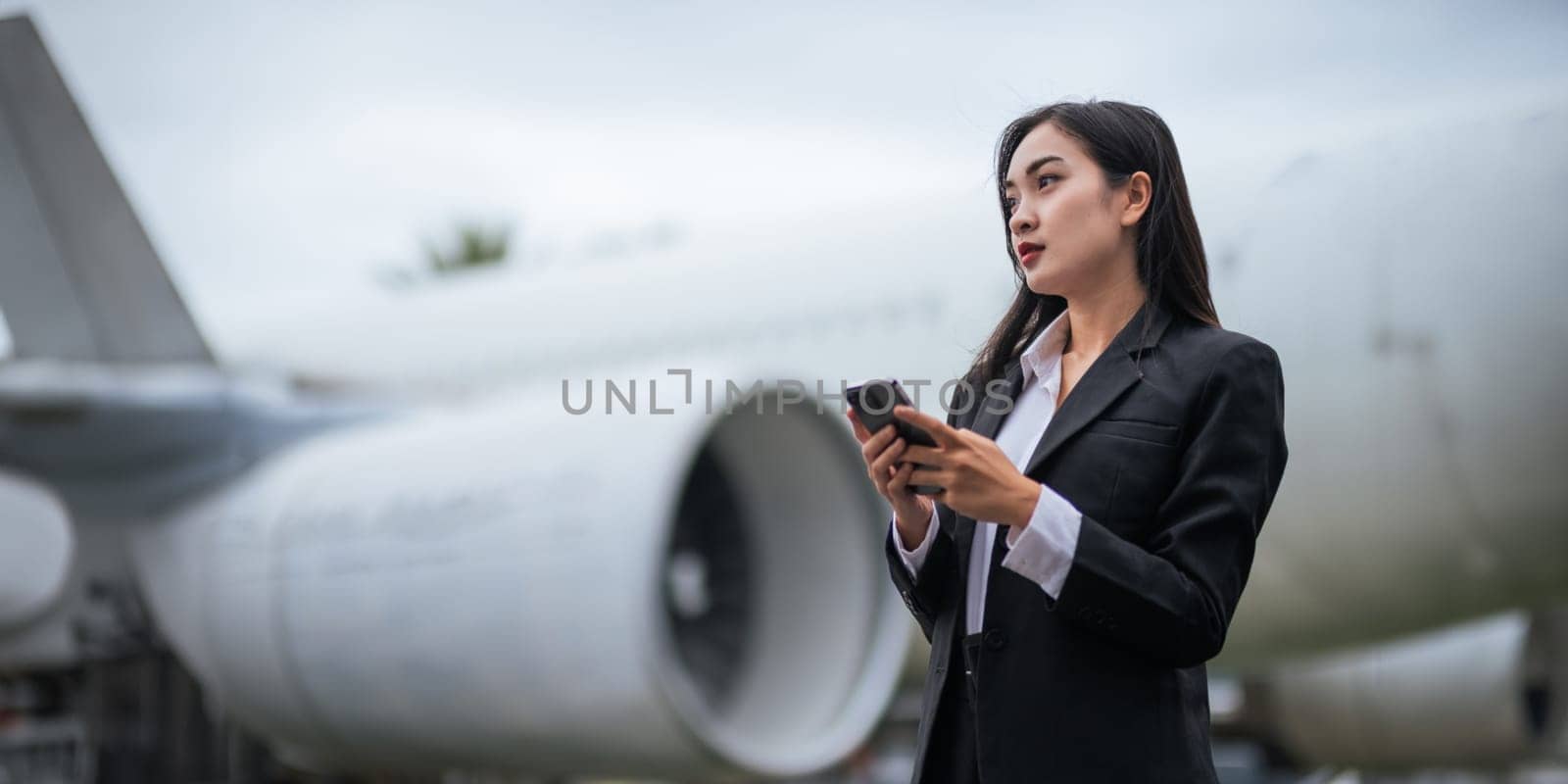 Successful business woman still traveling to work talking on mobile In the middle of the airport.