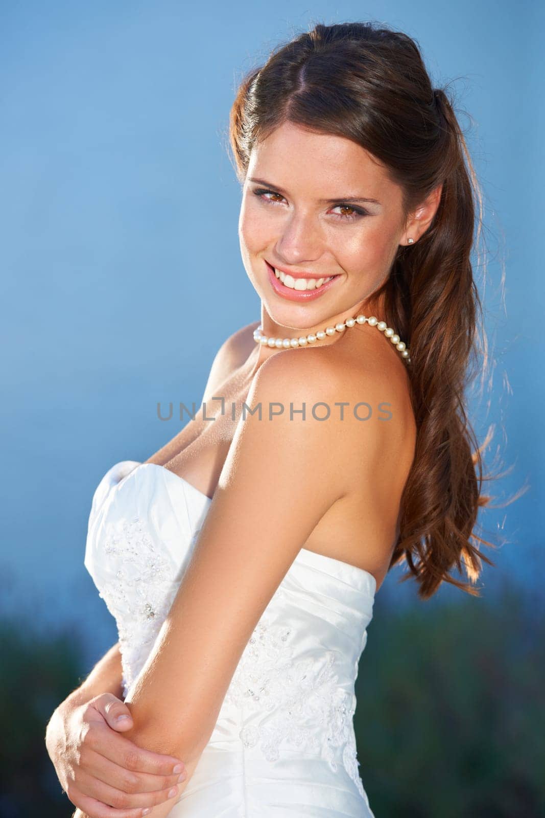 Bride, portrait and smile outdoor for love, commitment and celebration ceremony with confidence. Jewelry, woman and happy from future marriage, romance and formal event in a garden with a dress by YuriArcurs