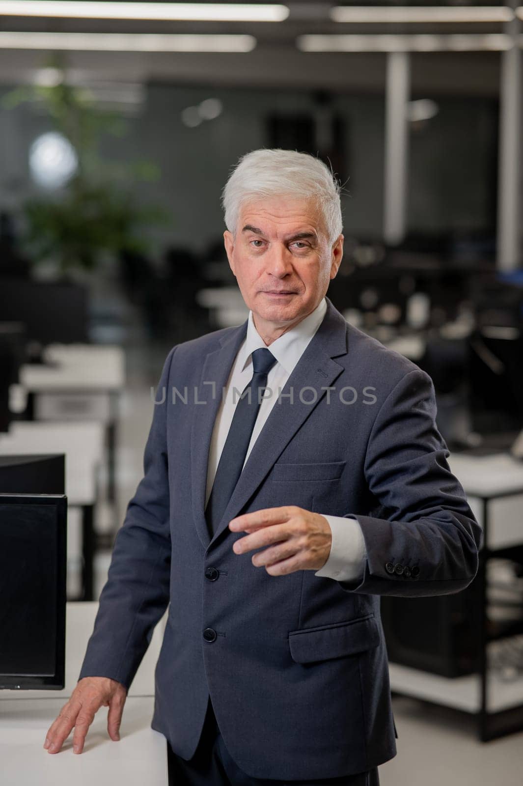 Confident mature business man in office. Vertical photo