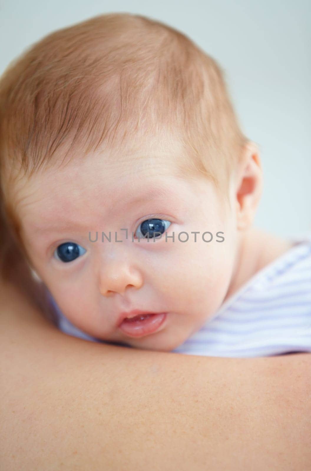 Family, shoulder and parent with baby in home for bonding, loving relationship and affection. Love, bedroom and closeup of mother carrying newborn for child development, growth and care in nursery.