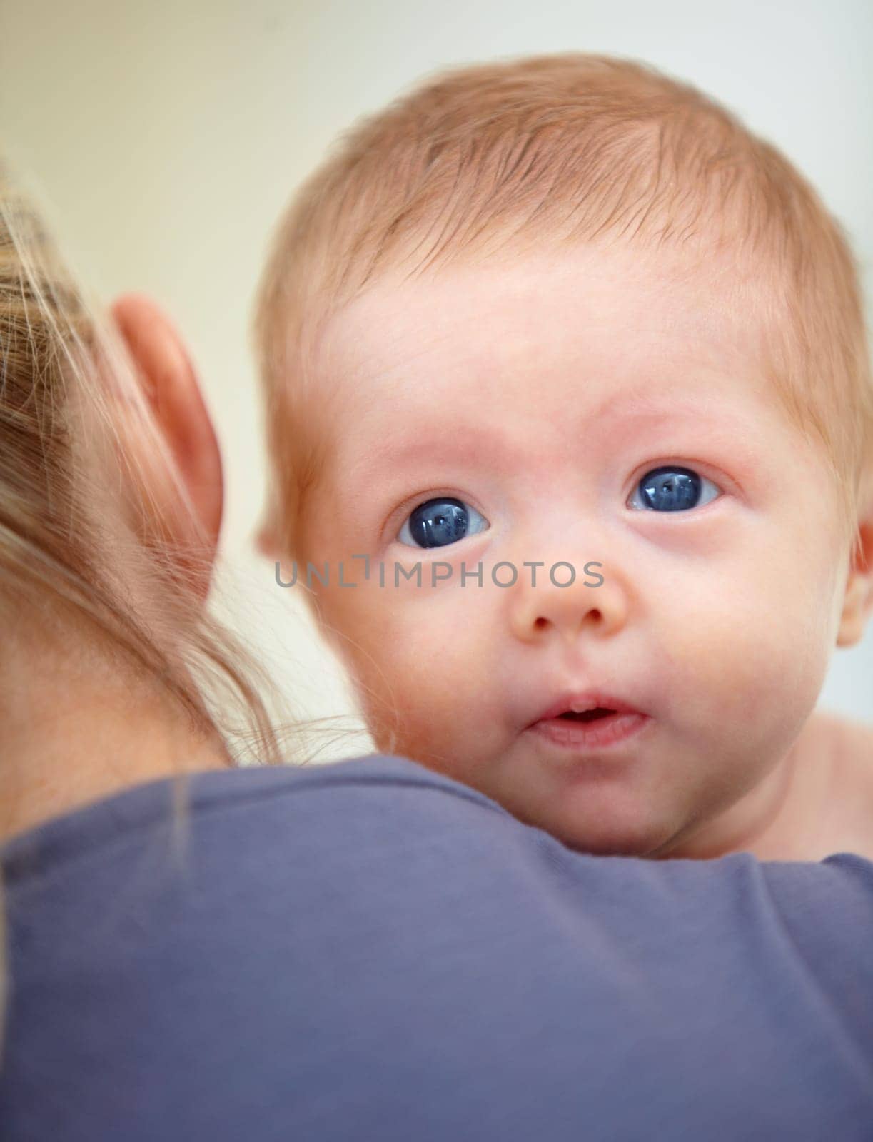 Family, shoulder and face of baby with mother in home for bonding, loving relationship and affection. Love, bedroom and parent carrying newborn for child development, growth and care in nursery.