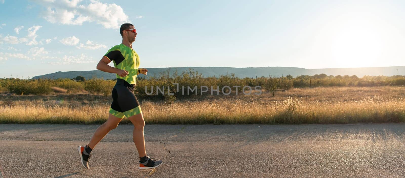 Triathlete in professional gear running early in the morning, preparing for a marathon, dedication to sport and readiness to take on the challenges of a marathon