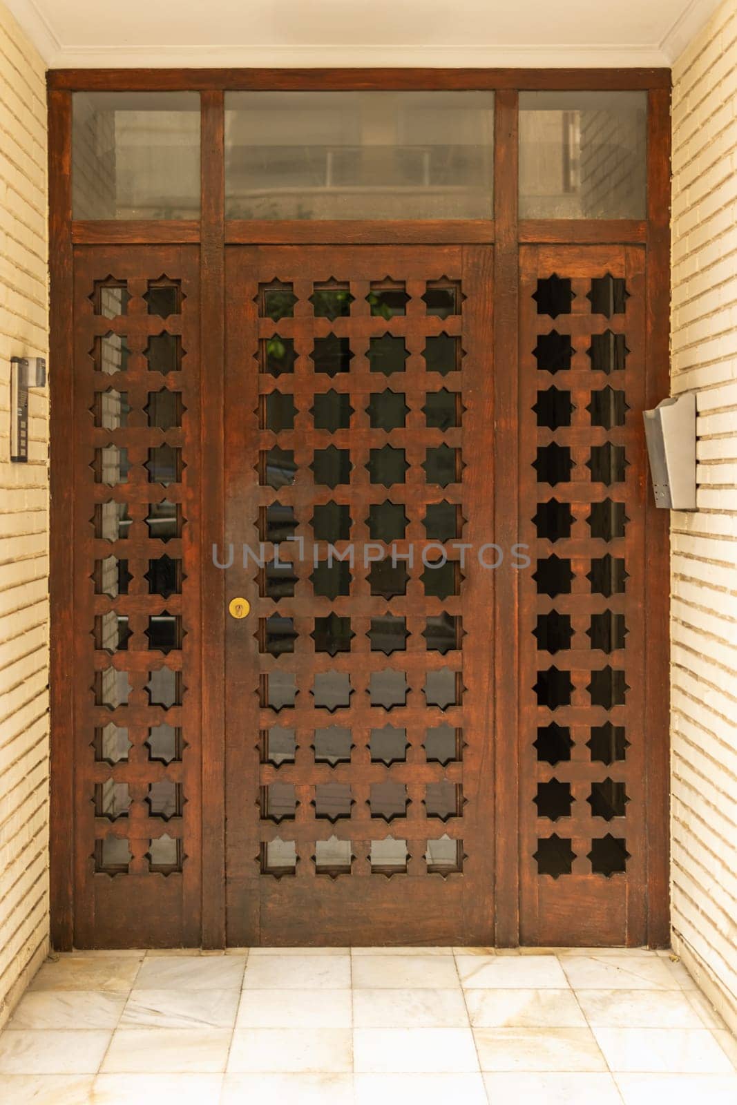 Old wooden entrance door to a house, door to a residential building, closed door, entrance to a residential building,. High quality photo