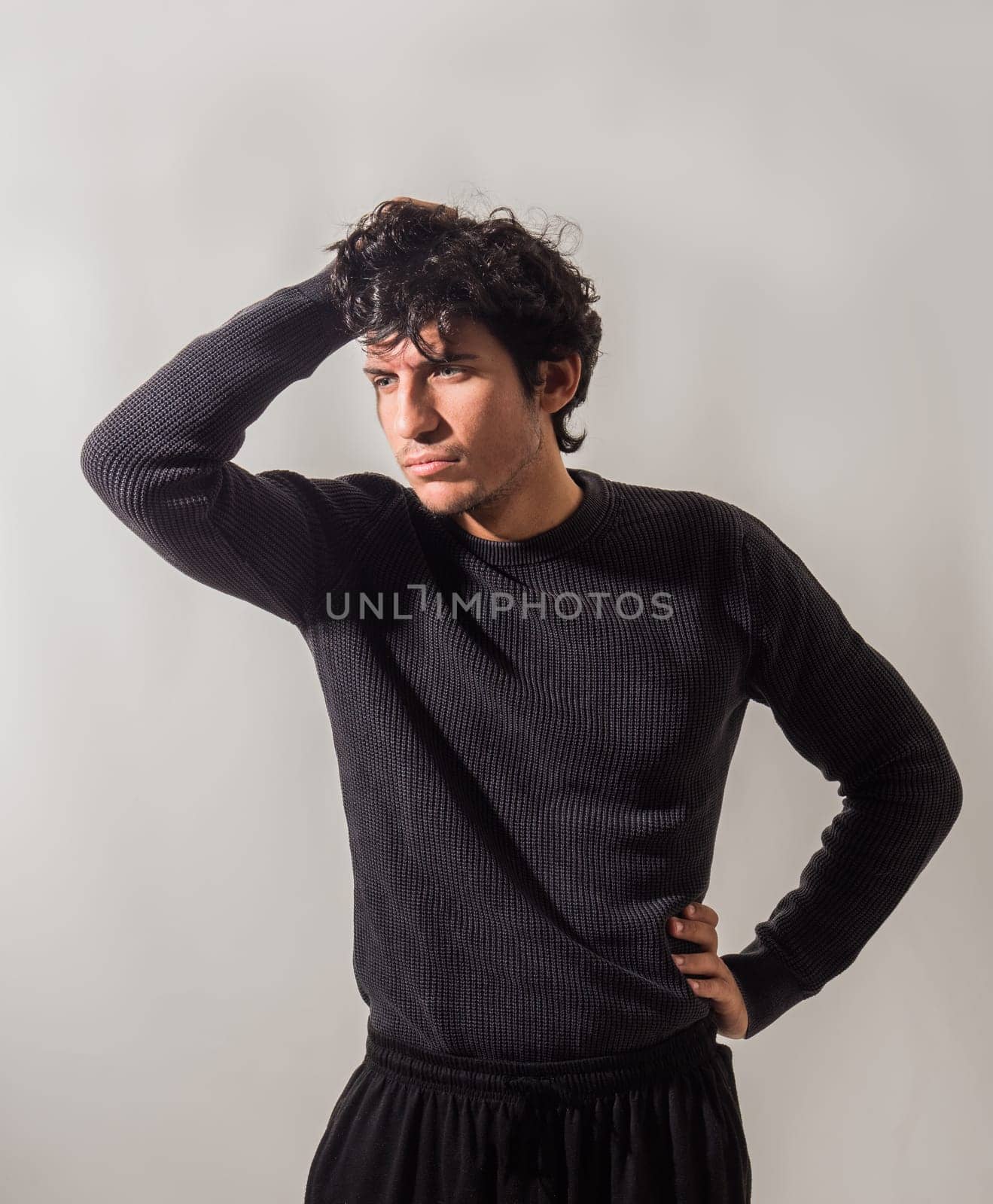 A Stylish Man Striking a Pose with His Hands on His Head by artofphoto