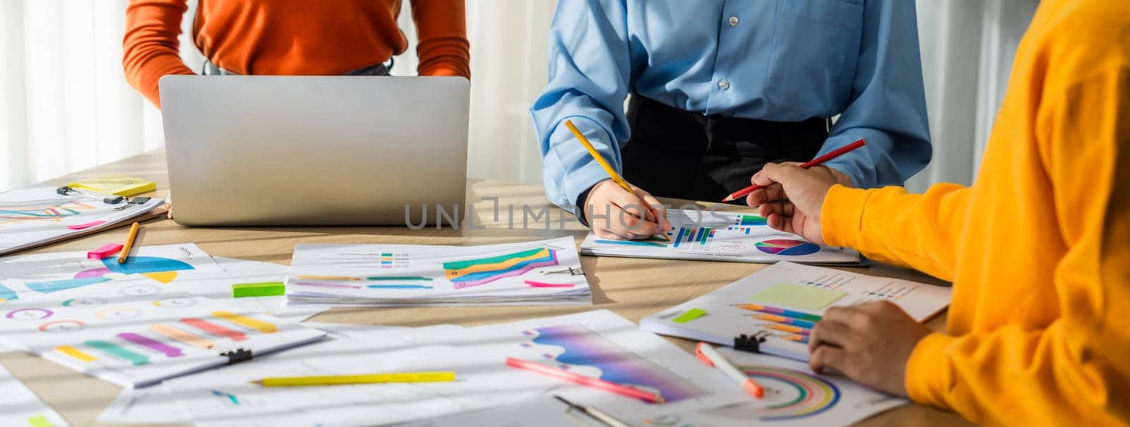 Startup company employee working together, analyzing BI dashboard paper on financial data report and planning strategic marketing for business success in panorama banner. Synergic