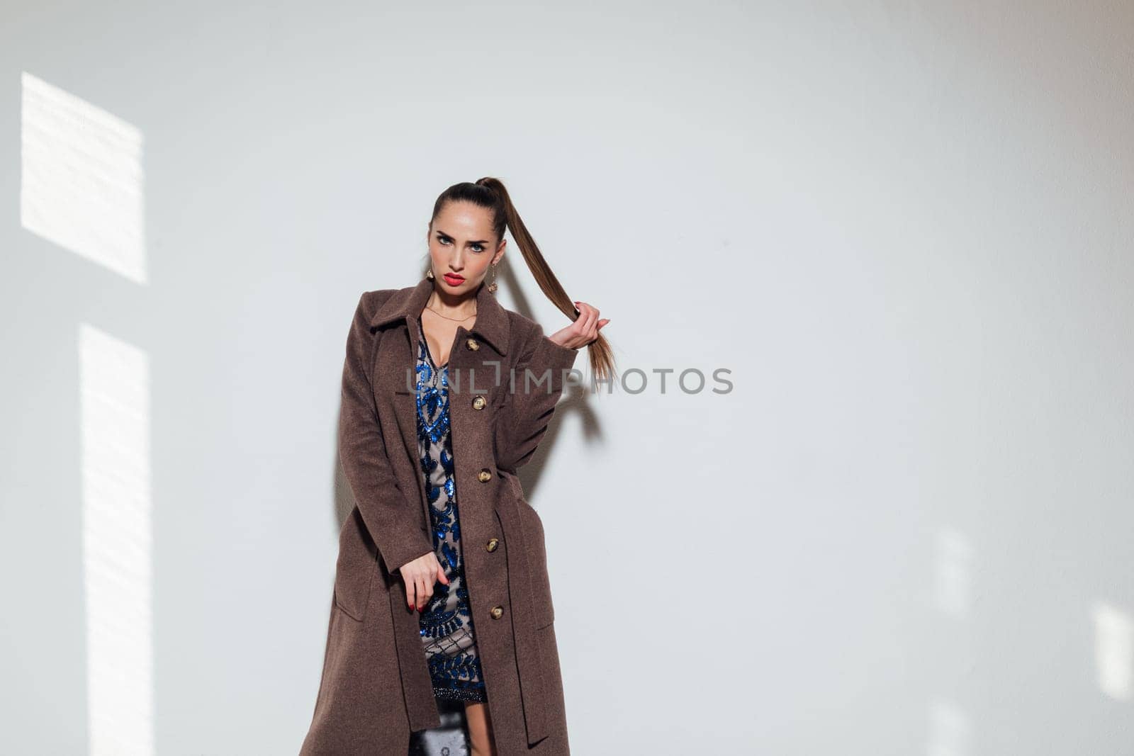 fashionable woman in a raincoat on a white background