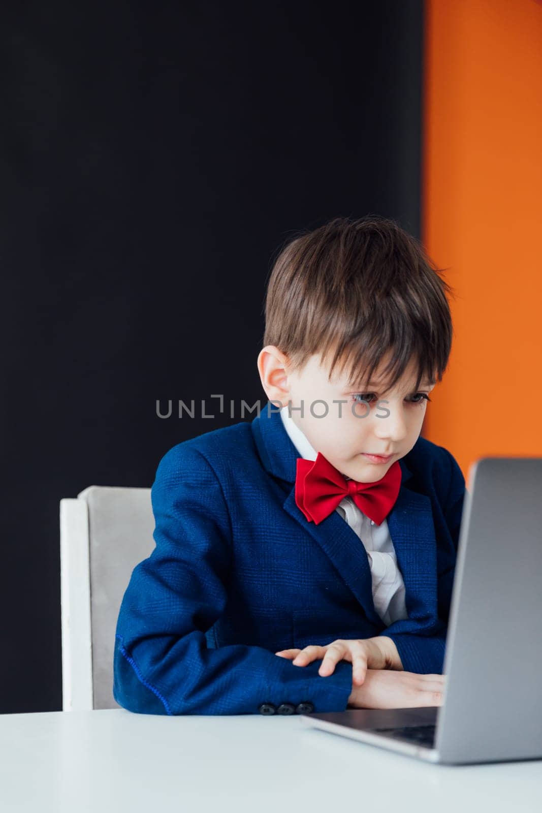 boy in the classroom at the computer online education skype communication by Simakov