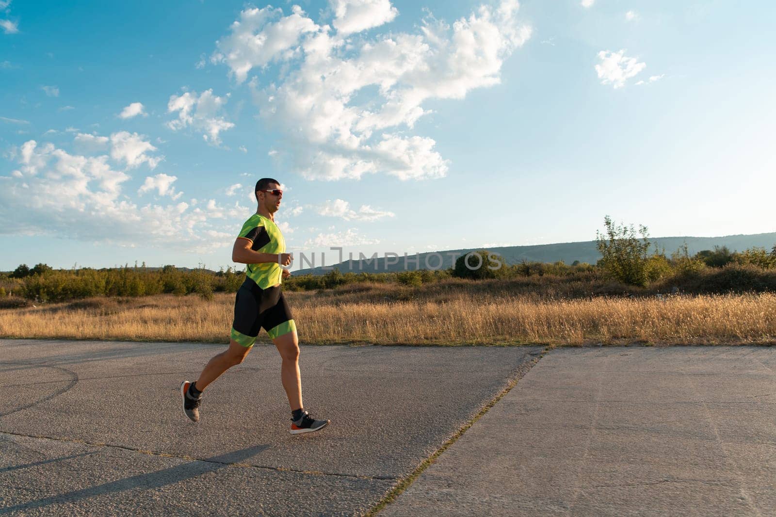 Triathlete in professional gear running early in the morning, preparing for a marathon, dedication to sport and readiness to take on the challenges of a marathon