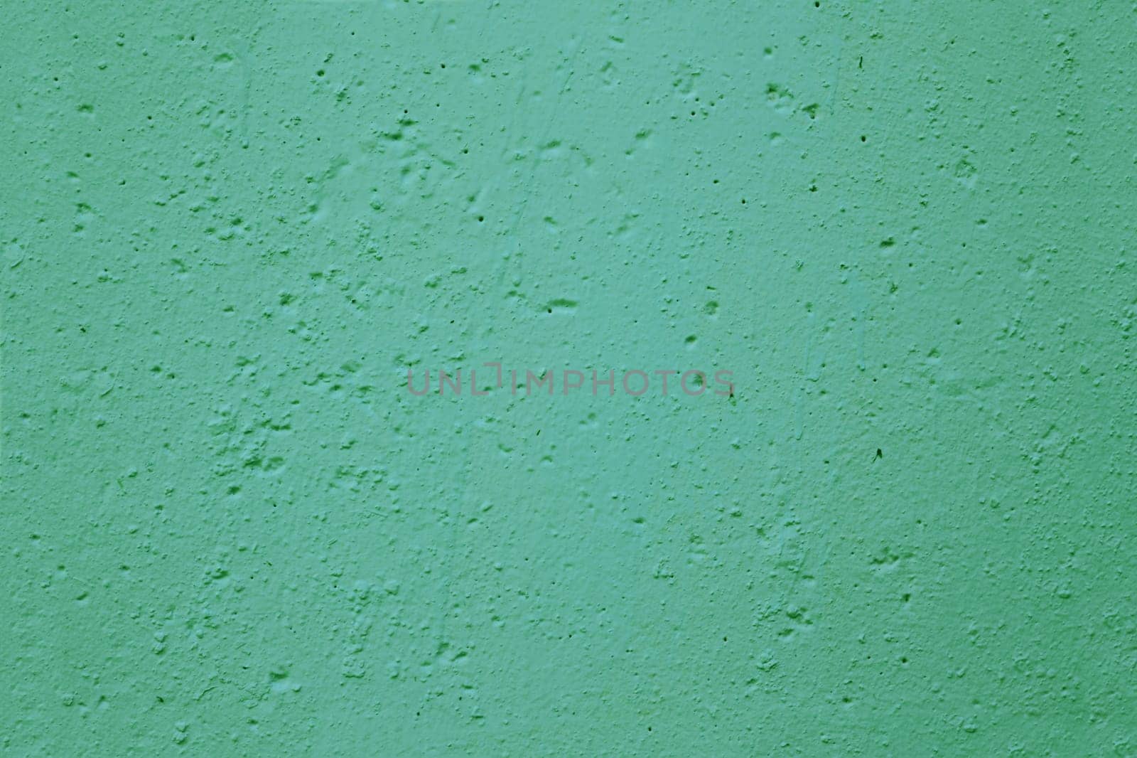 Texture of old green plaster on the wall.