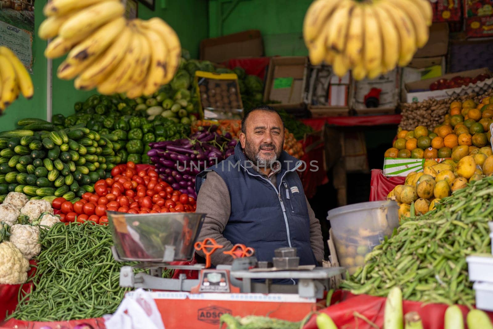 Leh, India - April 4, 2023: Seller at a fruit and vegetable shop in the historic city centre