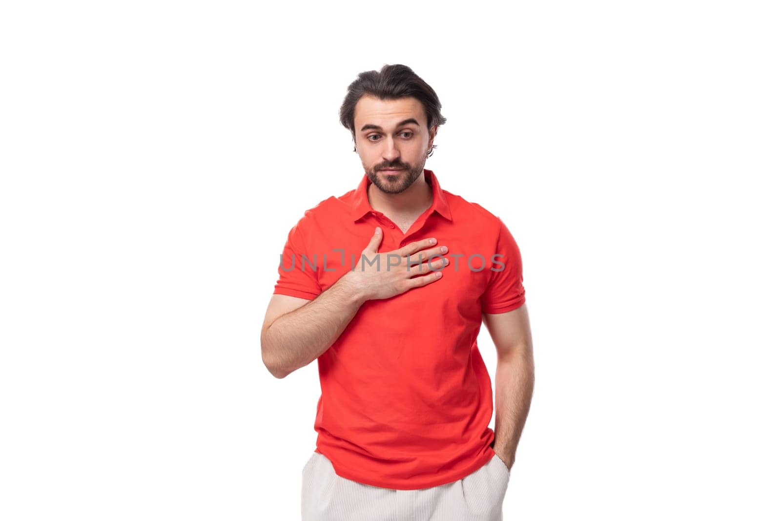 a young 35 year old european man with a styled haircut and beard dressed in a red t-shirt explains his idea.