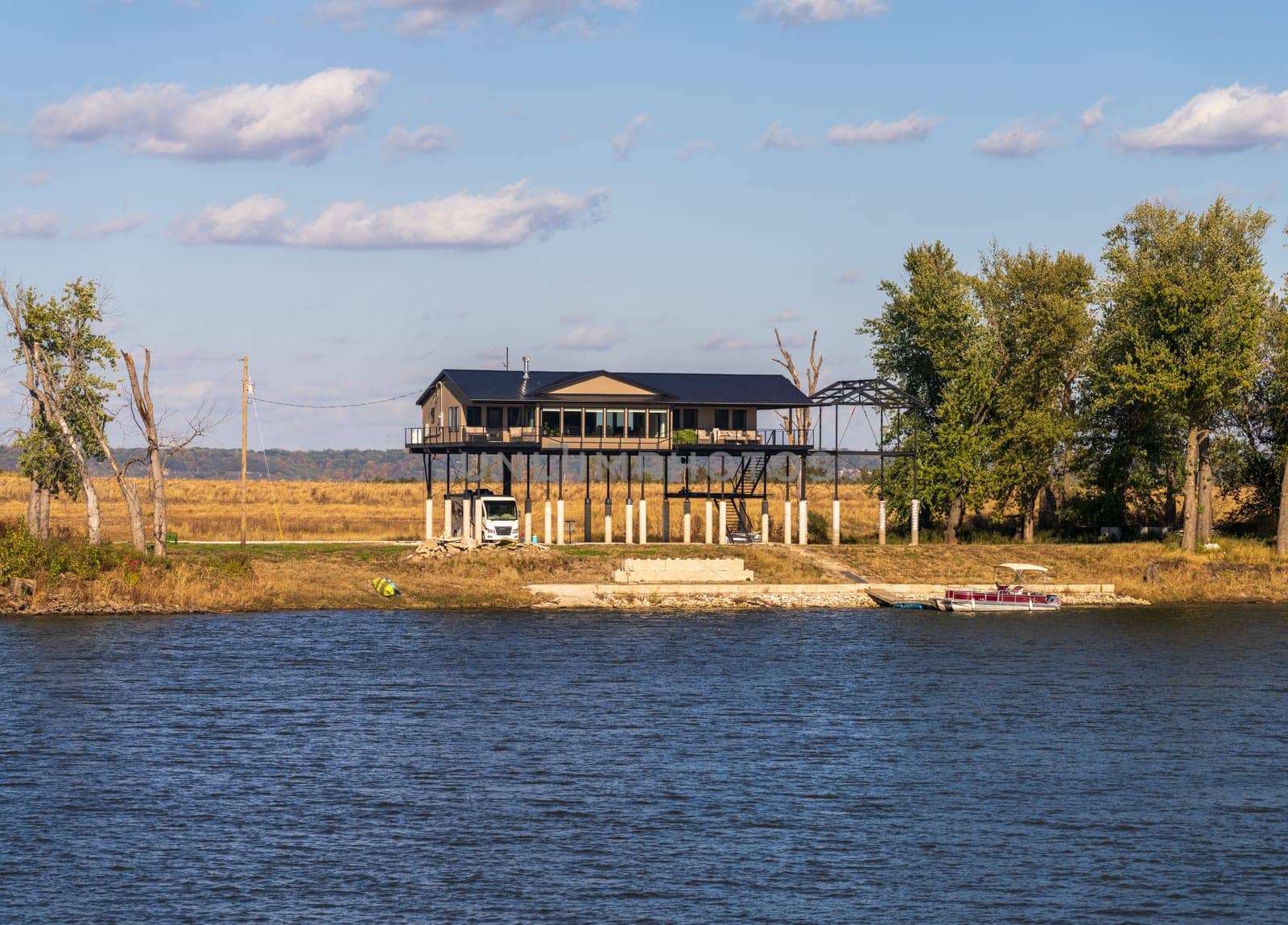 Modern home on very tall structure of stilts by the Mississippi river to protect against high water and floods