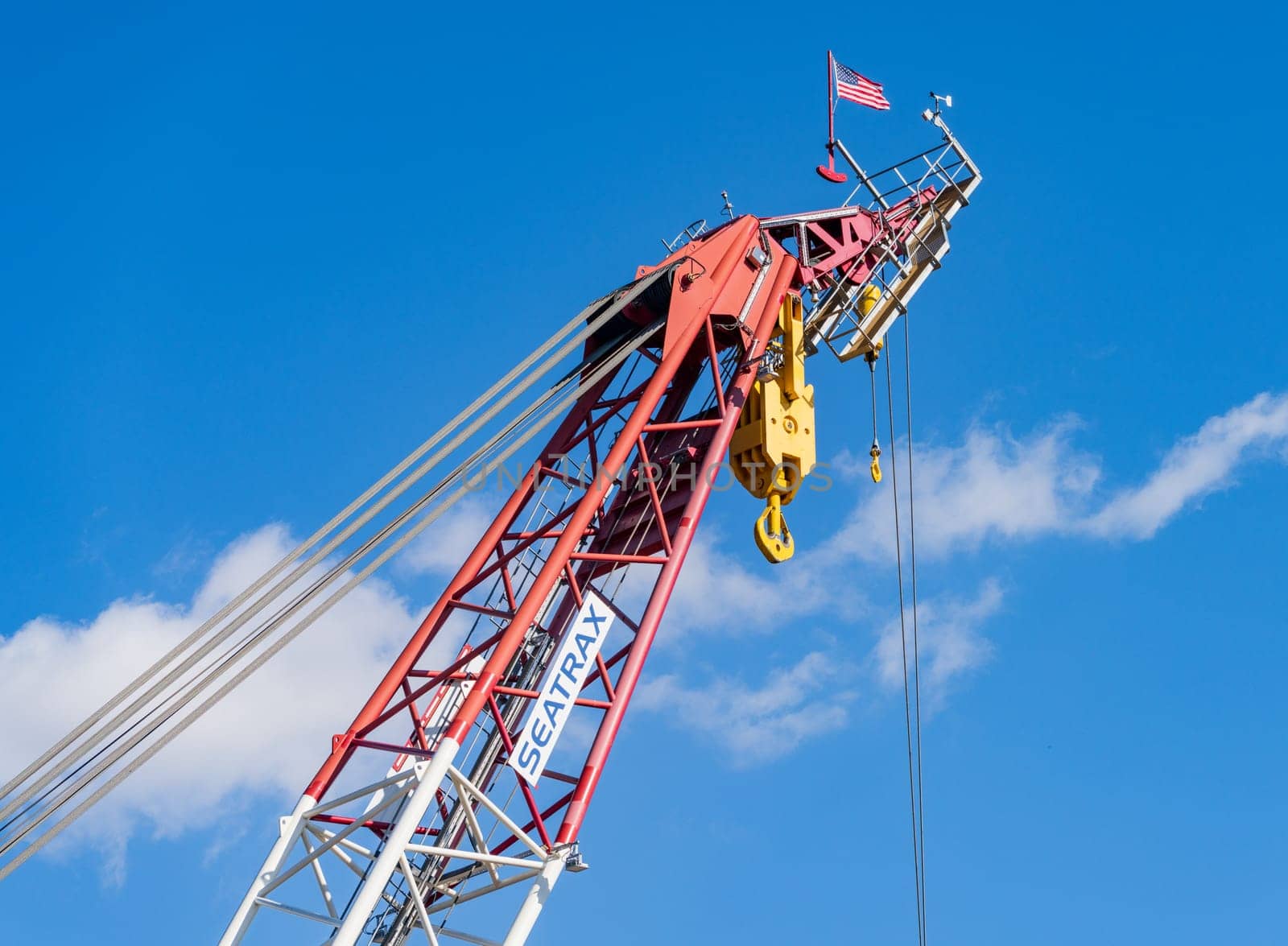 Detail of the many steel cables in powerful crane lifting heavy objects by steheap