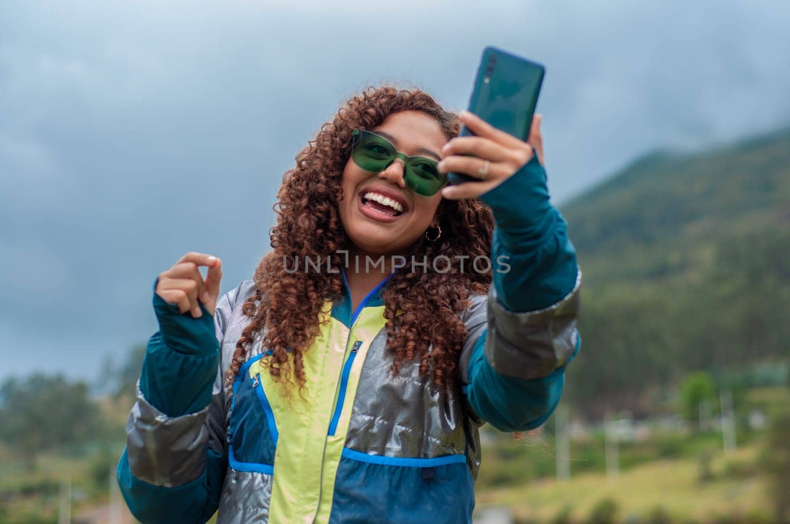 tourism vlogger connecting with his audience on a mountain in ecuador with a big smile. High quality photo