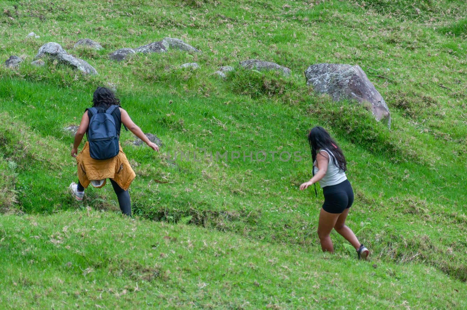 two friends climbing among rocks on a dangerous mountain in ecuador, south america. by Raulmartin