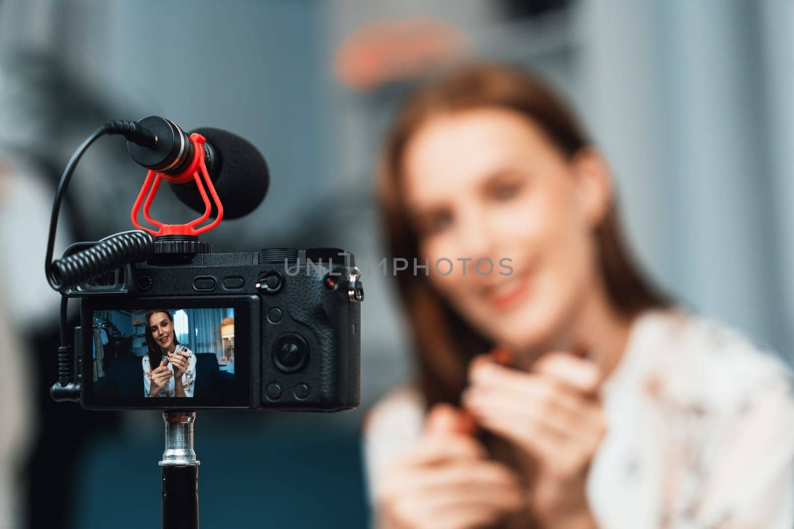 Woman influencer shoot live streaming vlog video review makeup utmost social media or blog. Happy young girl with cosmetics studio lighting for marketing recording session broadcasting online.