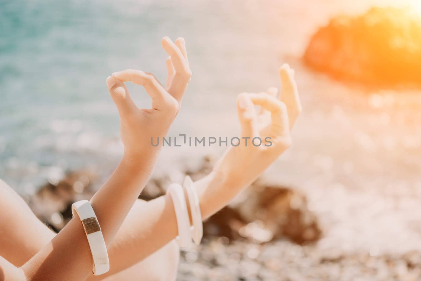 Close up Hand Gesture of Woman Doing an Outdoor Lotus Yoga Position. Close up. Blurred background