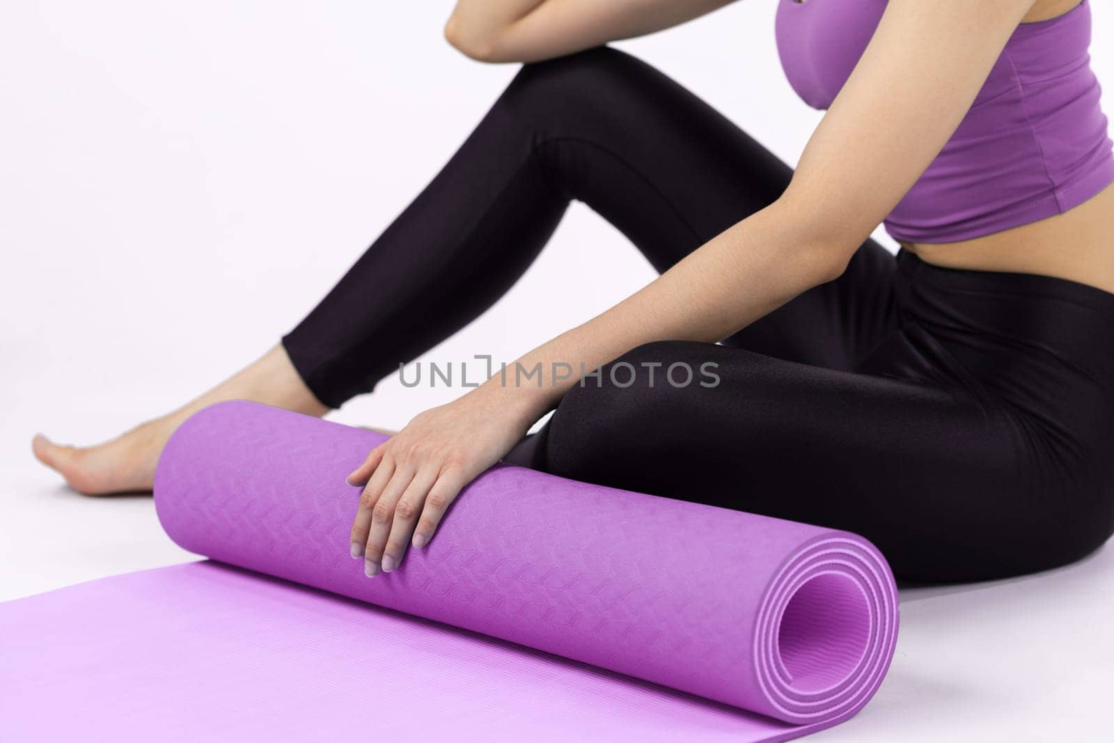 Young attractive asian woman portrait in sportswear with exercising mat. Healthy exercise and workout routine lifestyle concept. Studio shot isolated background. Vigorous