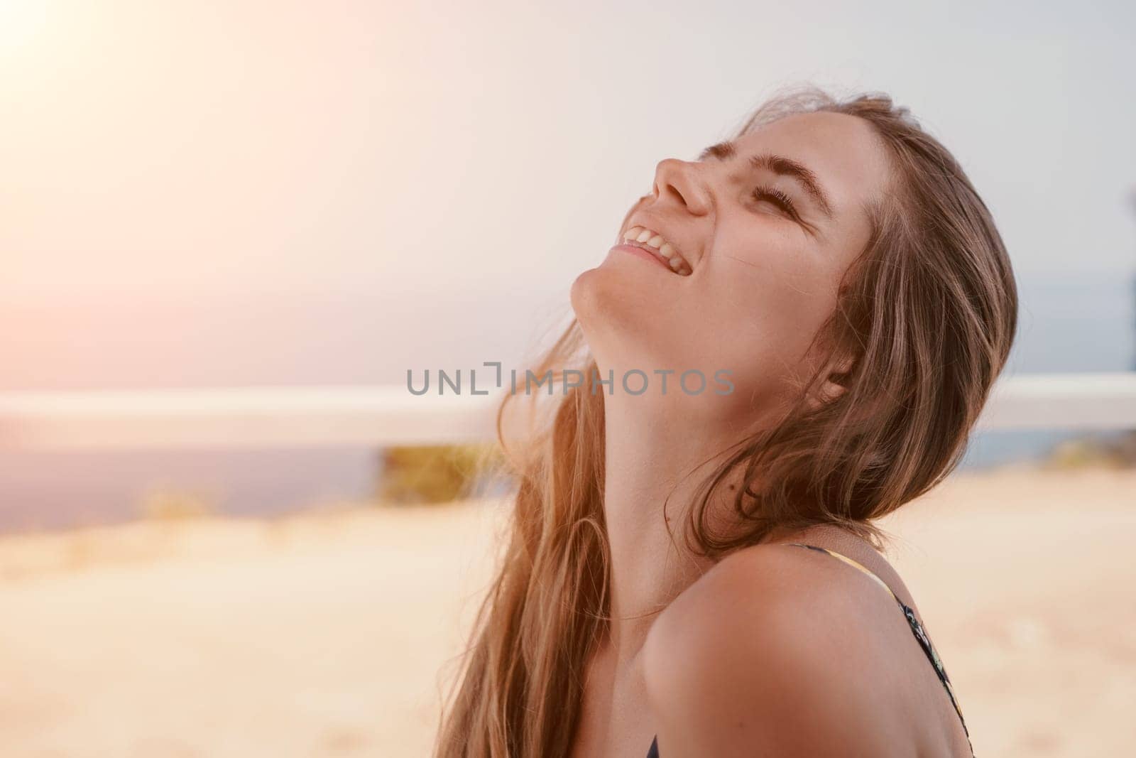 Happy woman portrait in cafe. Boho chic fashion style. Outdoor photo of young happy woman with long hair, sunny weather outdoors sitting in modern cafe