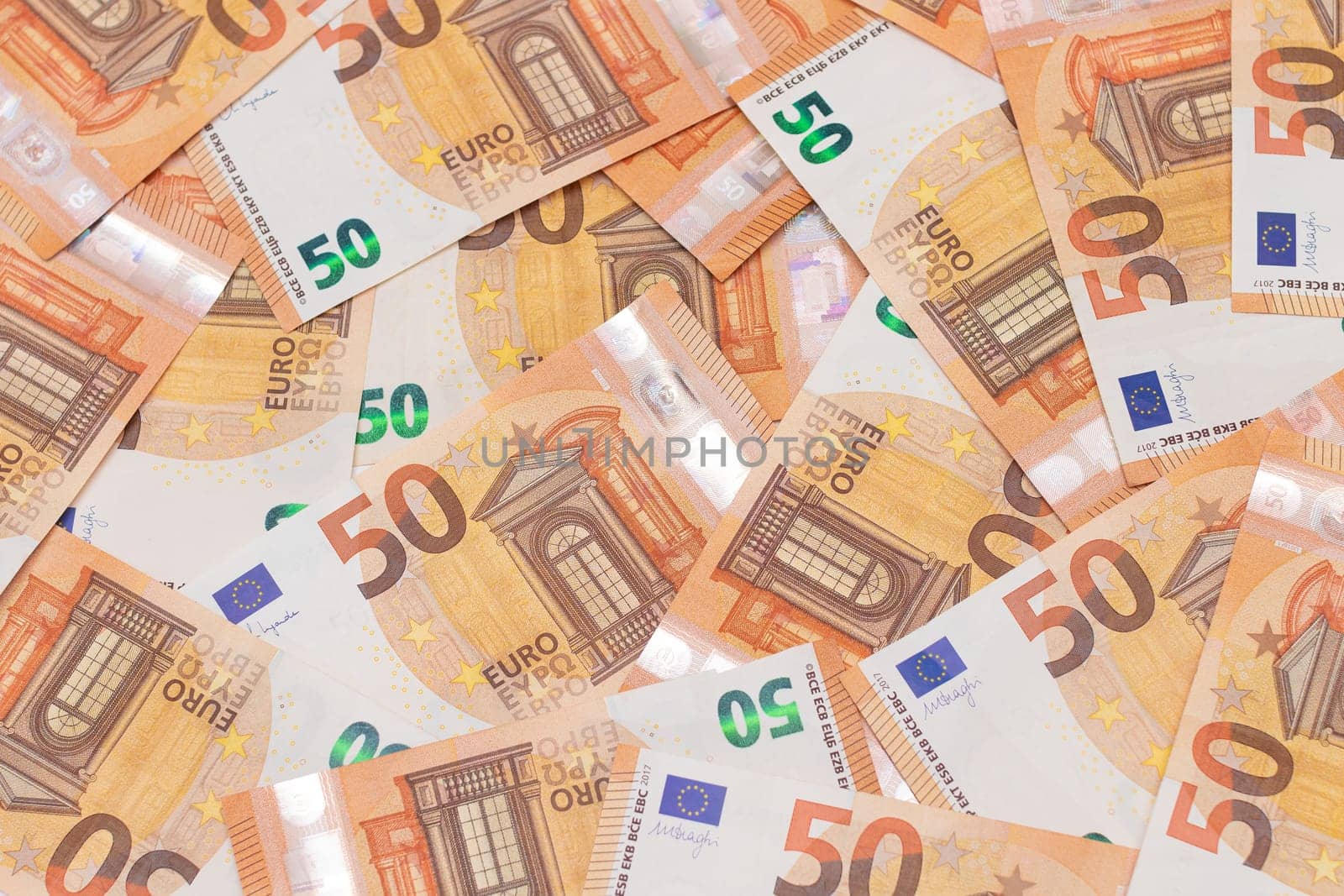 50 Euro Banknotes Money Background. Euro Money Currency. Orange Paper Money. A Lot of Fifty Euro Bills. Business, Finances, Cash and Money Saving Concept