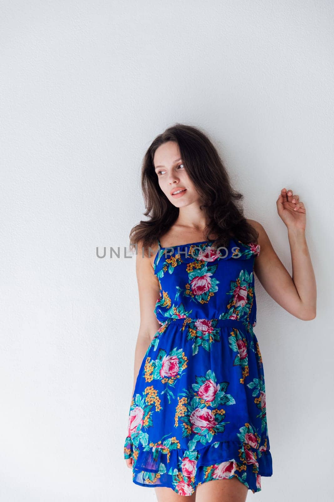 Brunette posing on white background in bright room by Simakov