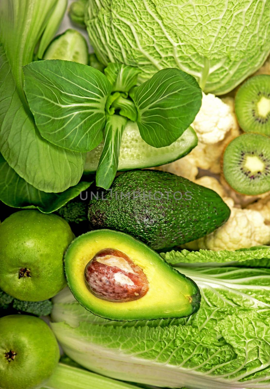 green still life. avocado, cabbage, apples, kiwi and other green vegetables