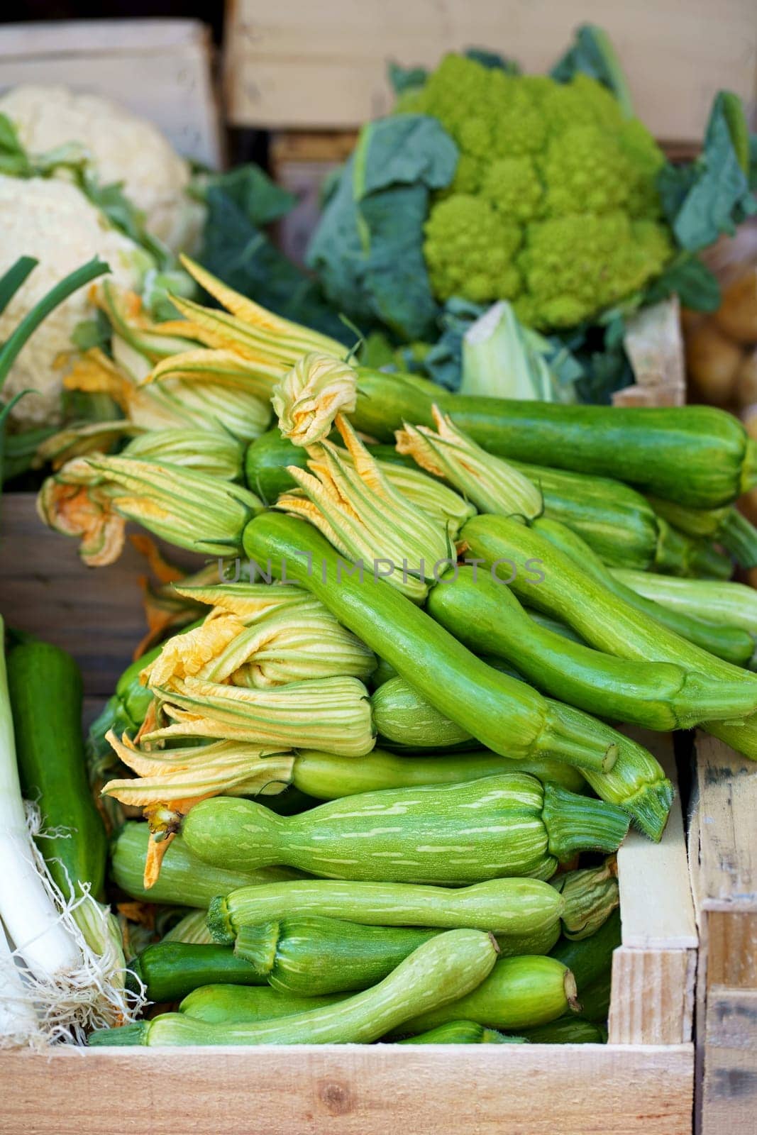 Nice. French market. Fresh zucchini with flowers sold at the market. Zucchini flowers are used in traditional French cuisine by aprilphoto