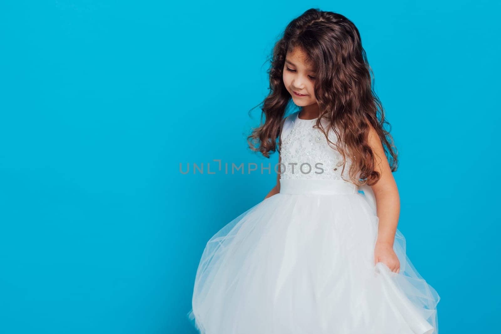 Beautiful girl in white dress on blue background