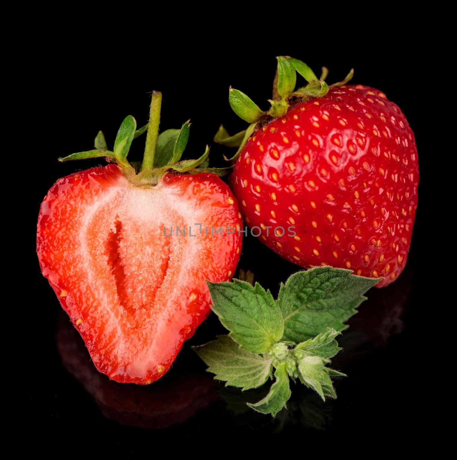 strawberry and mint on a black background