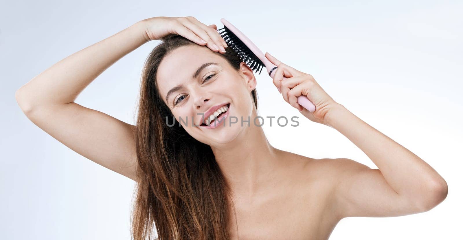 Portrait, happy woman and brush for hair in studio for beauty mock up on white background. Female model, laugh and excitement for detangle, treatment and texture with styling tool for scalp health.