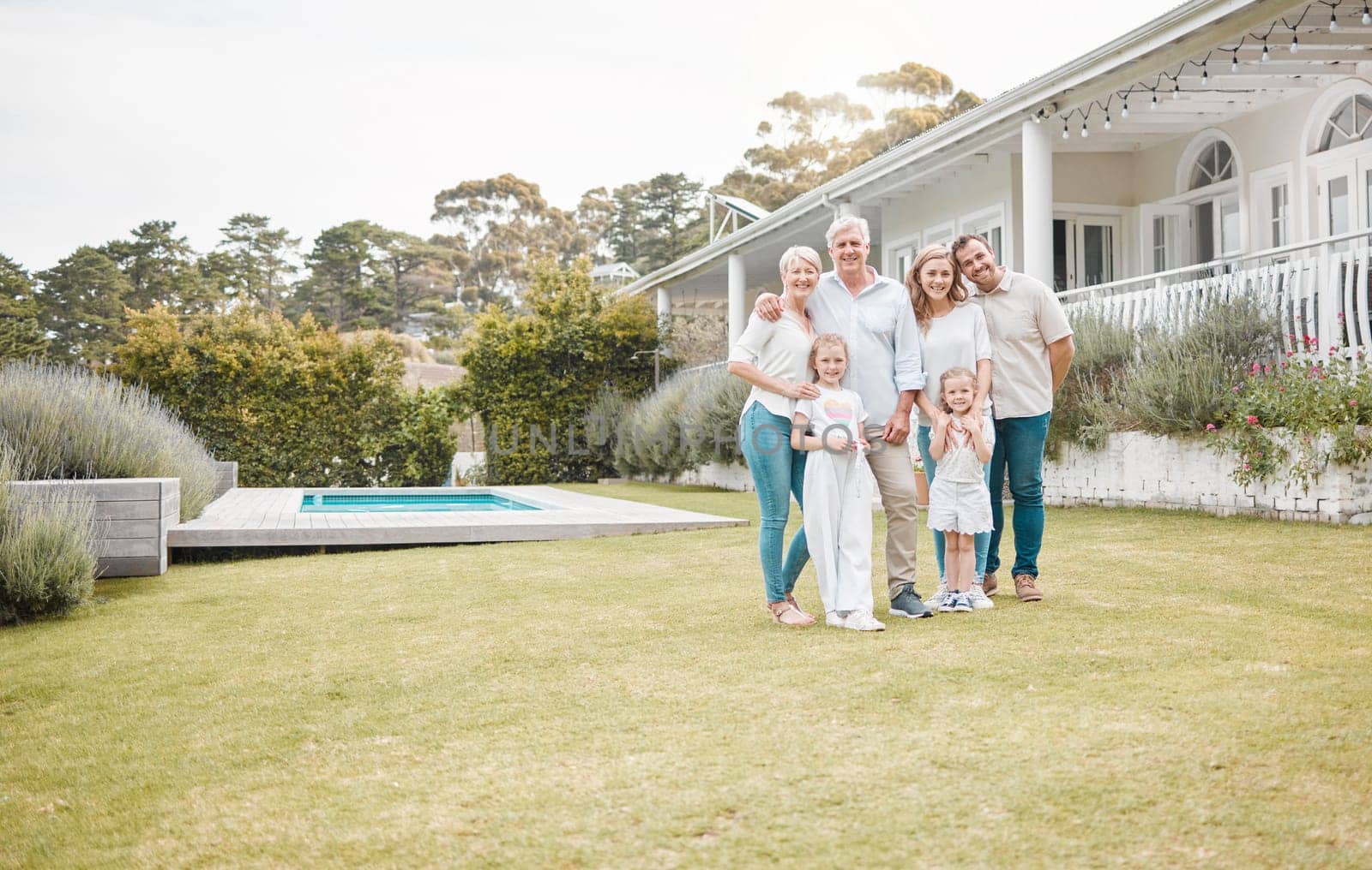 Portrait, real estate and a family in the garden of their new home together for a visit during summer. Children, parents and happy grandparents in the backyard for property investment with space by YuriArcurs