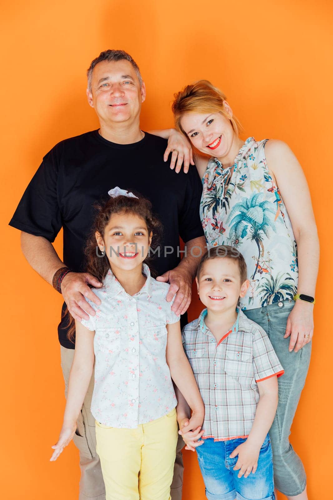Family photo of mom with dad and son with daughter by Simakov