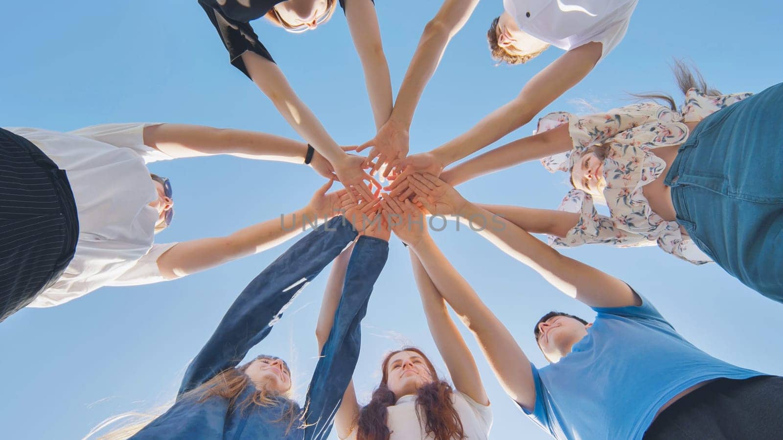 Friends putting their hands together in a sign of unity and teamwork. Just the hands