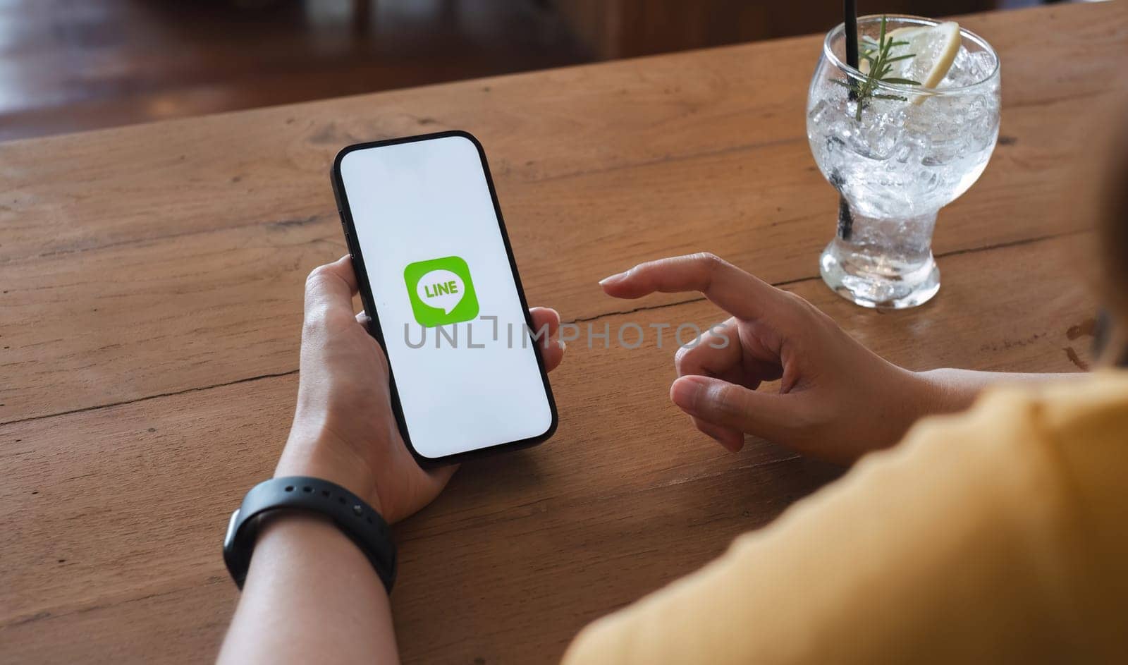 CHIANG MAI, THAILAND - NOV 16, 2023: Woman holding Apple iPhone 14 with LINE apps on screen. LINE is a new communication app which allows you to make free voice calls and send free messages by wichayada