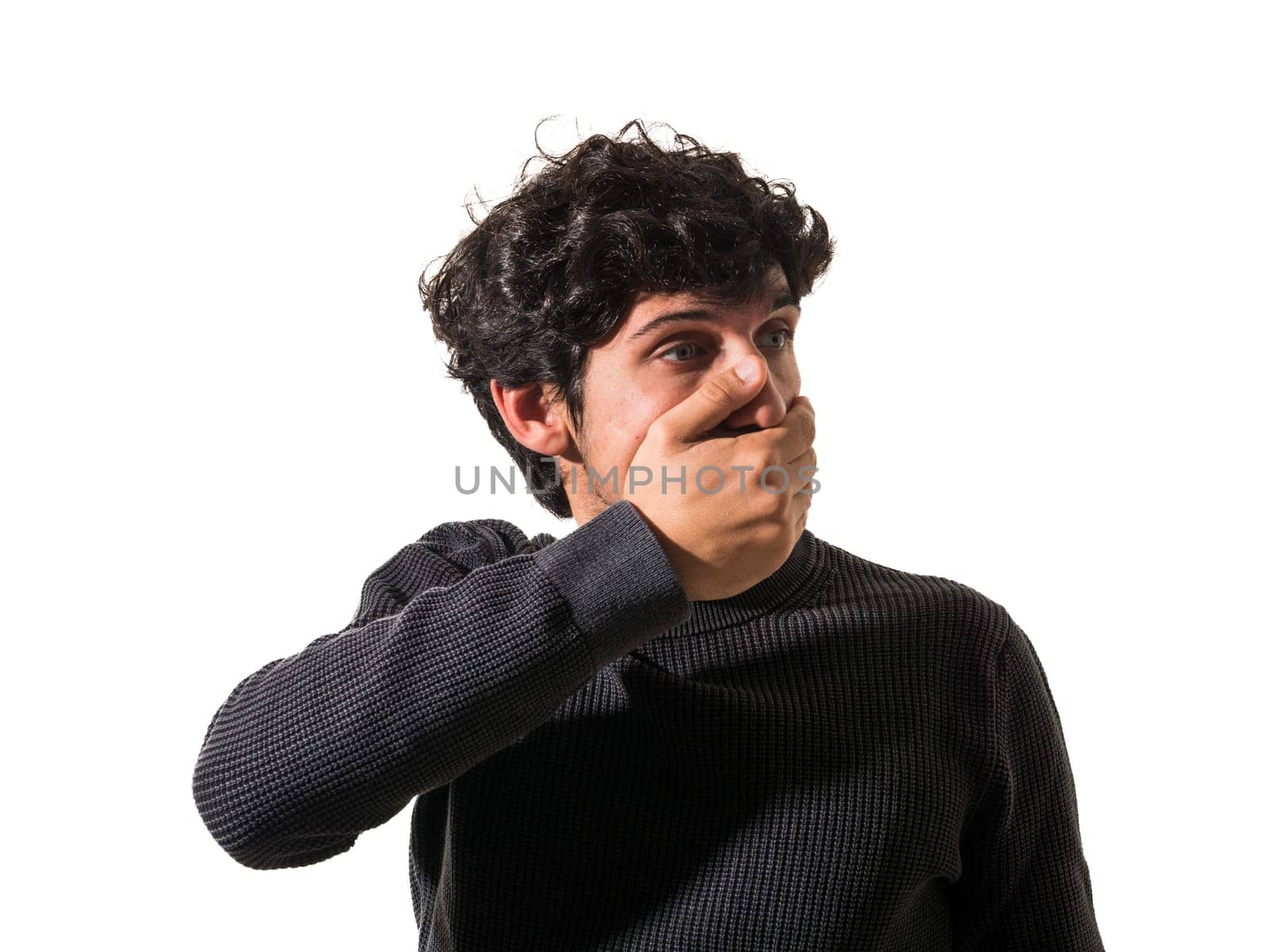 A man covering his mouth with his hands. A Man's Surprise and Shock Concealed Behind His Hands