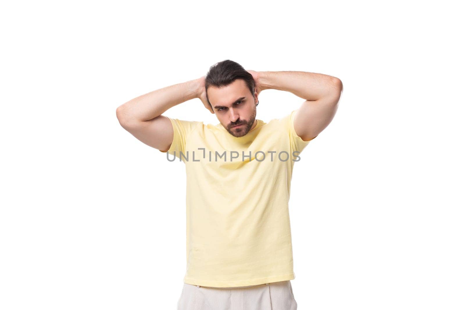 well-groomed young caucasian man with black hair and beard dressed in a t-shirt.