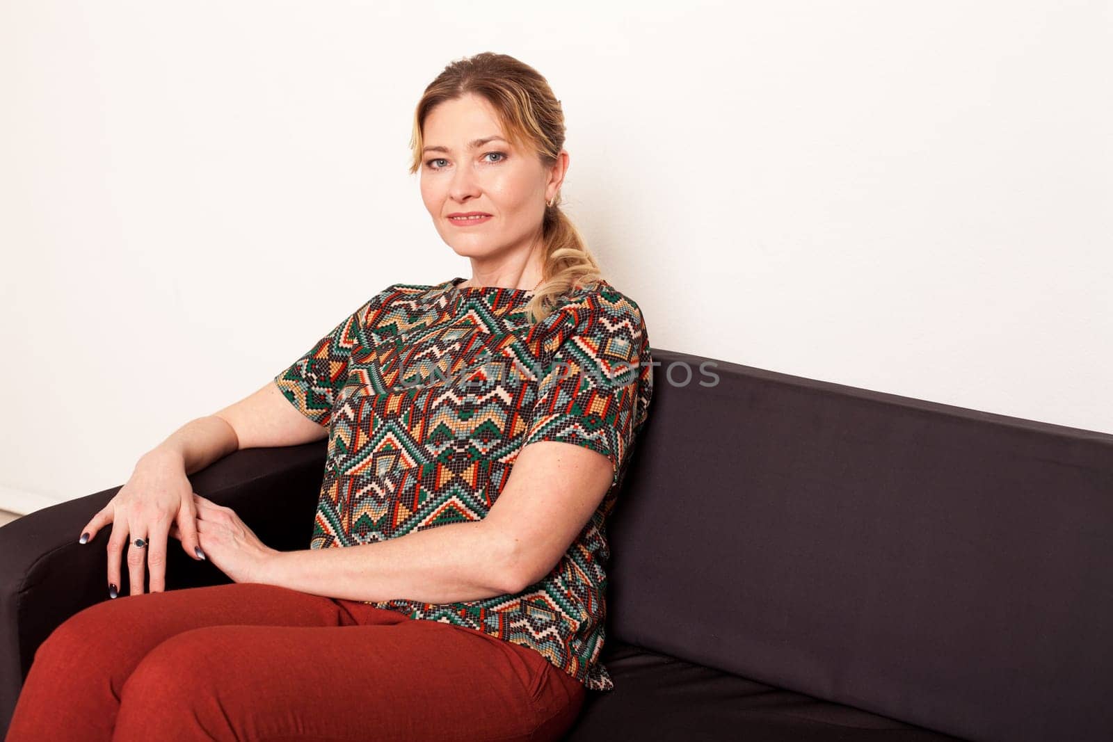 Woman sitting on couch in room